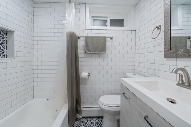 bathroom with toilet, tile patterned floors, tile walls, and vanity