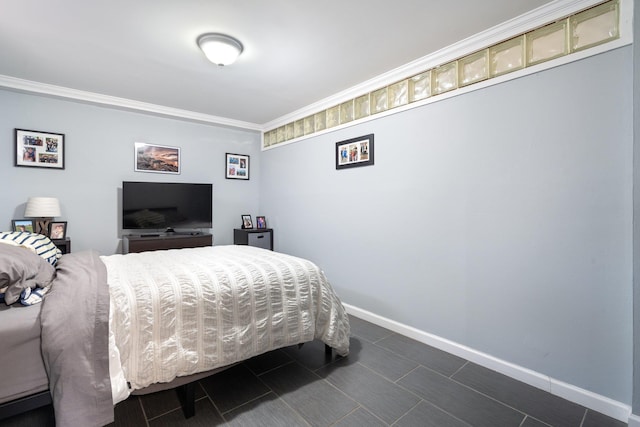 bedroom with crown molding and baseboards