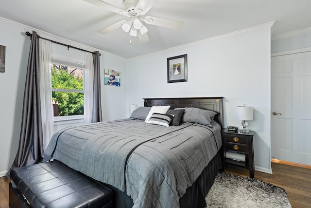 bedroom with baseboards, ornamental molding, a ceiling fan, and wood finished floors