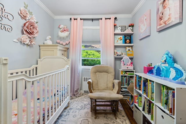 bedroom featuring crown molding, a nursery area, and radiator