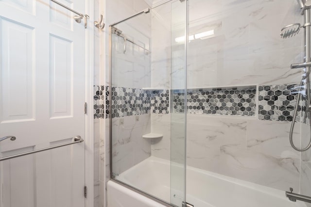 bathroom featuring bath / shower combo with glass door