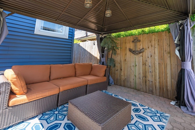 view of patio / terrace with a gazebo, outdoor lounge area, and fence
