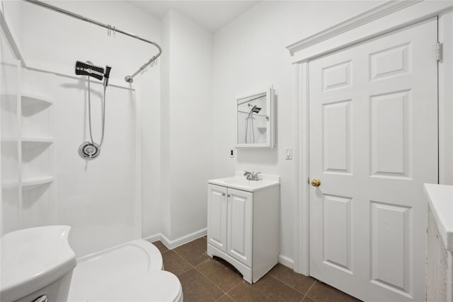 bathroom with baseboards, walk in shower, and toilet