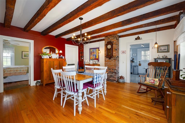 dining space with light wood-style floors, beamed ceiling, and a wealth of natural light