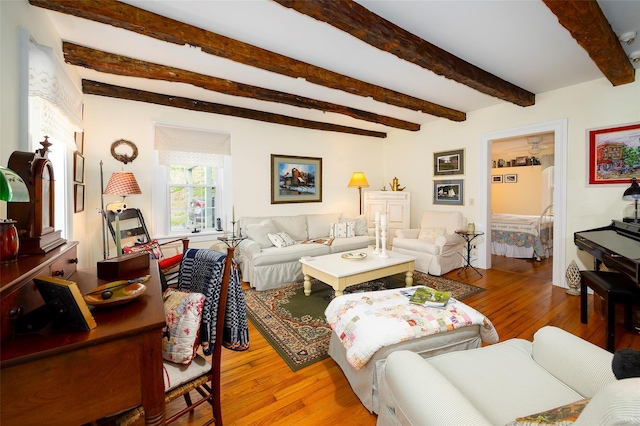 living area featuring beamed ceiling and wood-type flooring