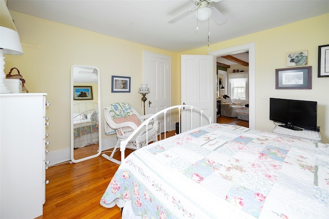 bedroom with baseboards, ceiling fan, and wood finished floors
