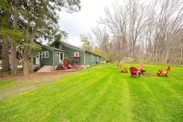 view of yard with an outdoor fire pit