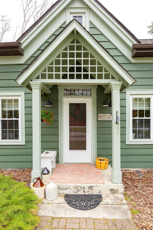 view of exterior entry featuring covered porch