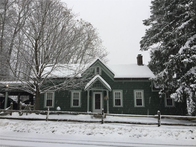 view of front of house with a chimney and fence private yard
