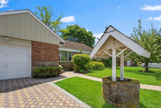 1037 Chestnut St, North Valley Stream, NY 11580 - view of front facade featuring brick siding, an attached garage, a front yard, board and batten siding, and stone siding