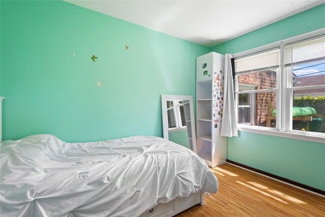 1037 Chestnut St, North Valley Stream, NY 11580 - bedroom with wood finished floors and baseboards
