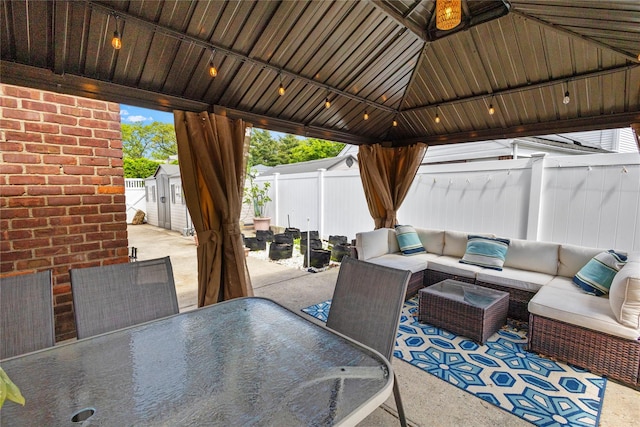 1037 Chestnut St, North Valley Stream, NY 11580 - view of patio with outdoor dining area, a fenced backyard, an outdoor living space, a gazebo, and a storage shed