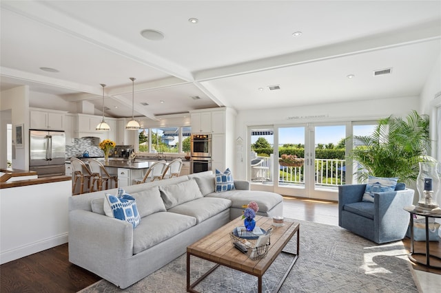 living area featuring recessed lighting, beamed ceiling, dark wood finished floors, and visible vents