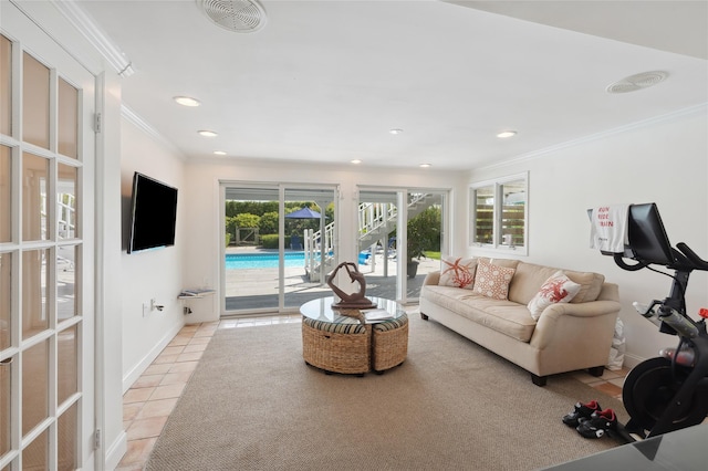 living area with crown molding, light tile patterned floors, a healthy amount of sunlight, and visible vents