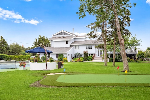 view of property's community with a lawn and fence