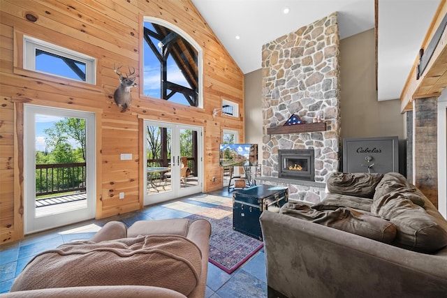 535 County Route 22, Middletown, NY 10940 - living area featuring high vaulted ceiling, a stone fireplace, wooden walls, stone tile flooring, and french doors