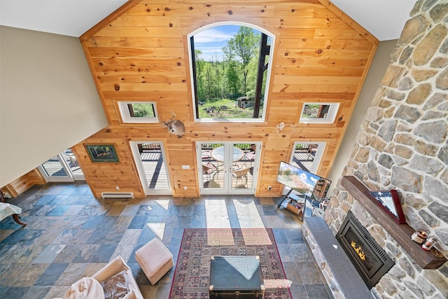 535 County Route 22, Middletown, NY 10940 - living area with wood walls, stone tile flooring, healthy amount of natural light, french doors, and a high ceiling
