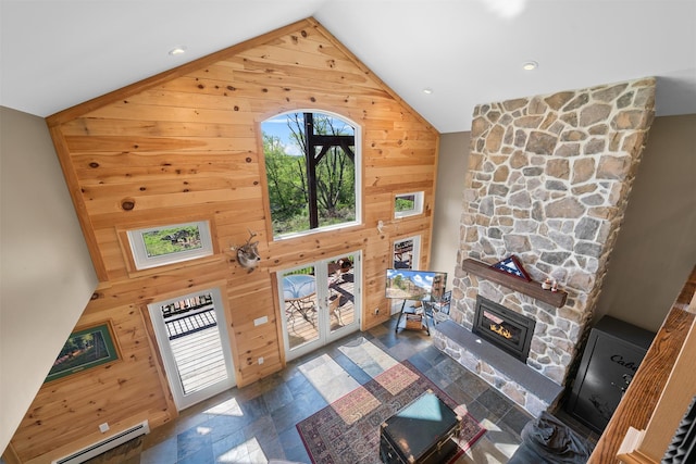 535 County Route 22, Middletown, NY 10940 - living room with wooden walls, plenty of natural light, high vaulted ceiling, a fireplace, and a baseboard radiator
