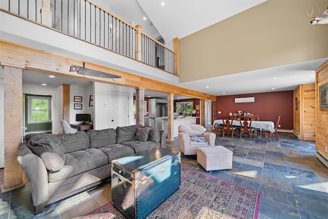 535 County Route 22, Middletown, NY 10940 - living room featuring a wall mounted AC, stone tile floors, baseboards, recessed lighting, and high vaulted ceiling