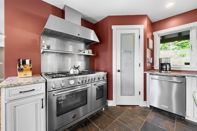 535 County Route 22, Middletown, NY 10940 - kitchen with appliances with stainless steel finishes, wall chimney exhaust hood, light stone countertops, baseboards, and white cabinetry