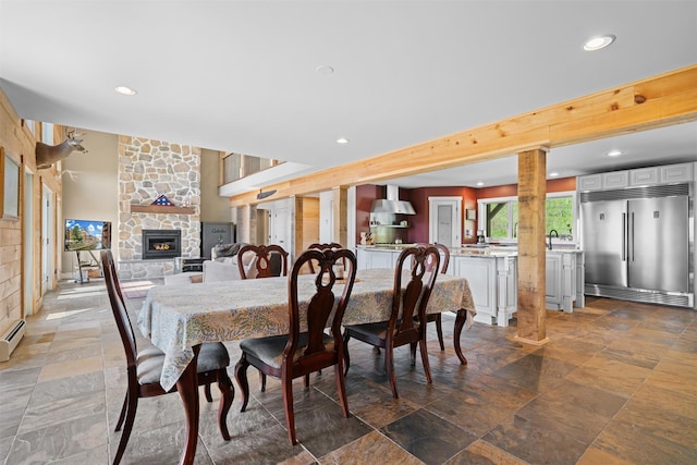 535 County Route 22, Middletown, NY 10940 - dining room with a fireplace, recessed lighting, stone tile floors, and a baseboard heating unit