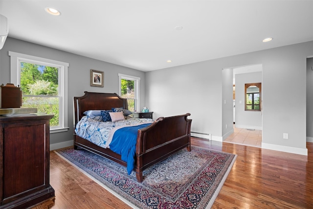 535 County Route 22, Middletown, NY 10940 - bedroom featuring a baseboard radiator, multiple windows, wood finished floors, and recessed lighting
