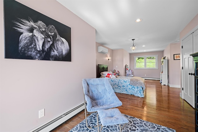 535 County Route 22, Middletown, NY 10940 - bedroom featuring a wall unit AC, a baseboard radiator, wood finished floors, recessed lighting, and baseboards
