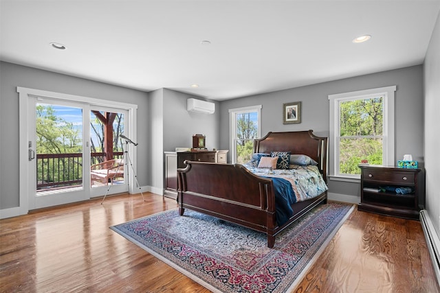 535 County Route 22, Middletown, NY 10940 - bedroom with an AC wall unit, access to exterior, wood finished floors, recessed lighting, and baseboard heating