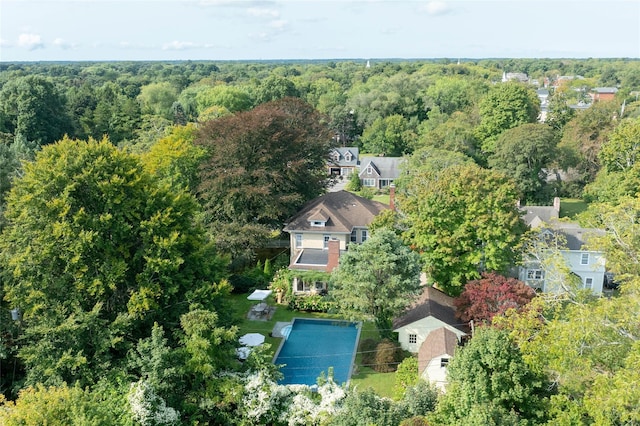 drone / aerial view featuring a wooded view
