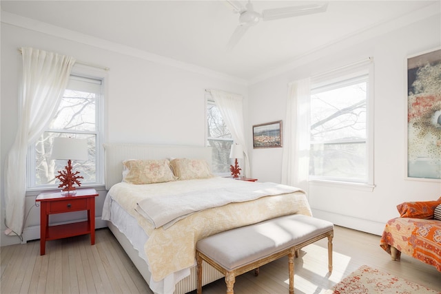 bedroom featuring crown molding, ceiling fan, and light wood finished floors
