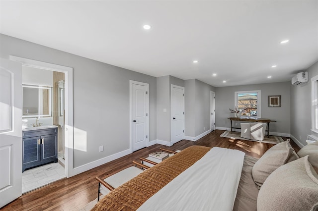 living area with baseboards, recessed lighting, a wall mounted air conditioner, and wood finished floors