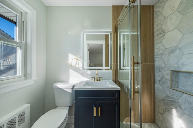 full bathroom with a shower stall, a healthy amount of sunlight, and radiator