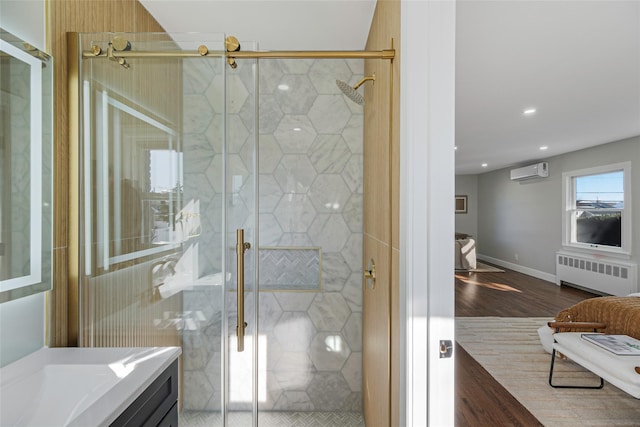 bathroom with radiator heating unit, a shower stall, a wall mounted air conditioner, and wood finished floors