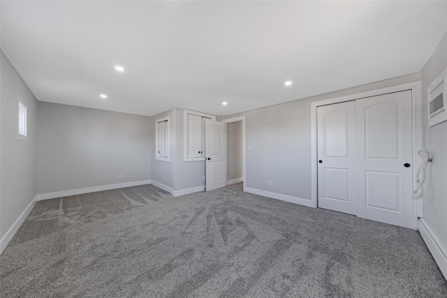 unfurnished bedroom with recessed lighting, carpet flooring, baseboards, and multiple closets