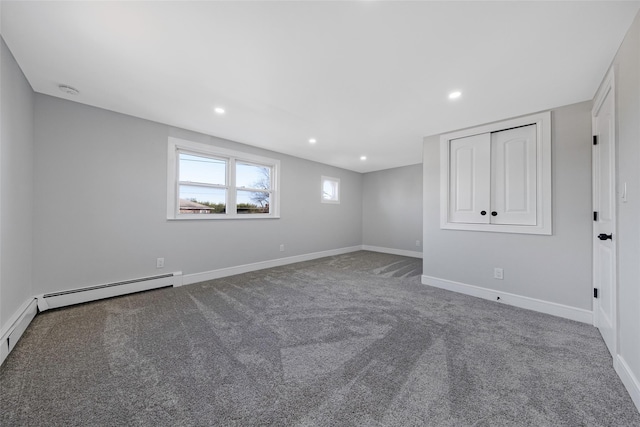 unfurnished bedroom with baseboards, a baseboard radiator, carpet, and recessed lighting