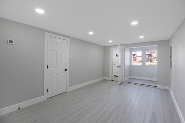 below grade area with recessed lighting, baseboards, and light wood-style floors