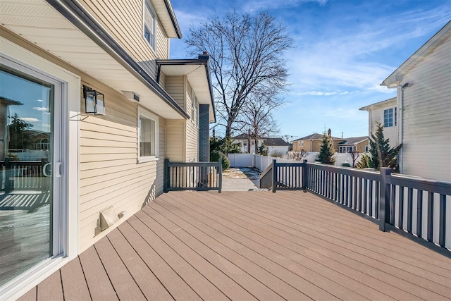 wooden terrace with fence and a residential view