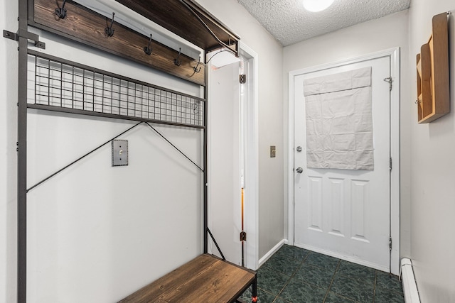 doorway with baseboards, a baseboard radiator, and a textured ceiling