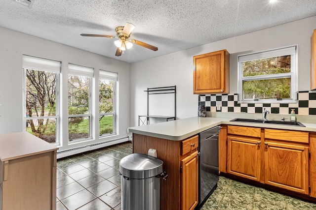 kitchen with a ceiling fan, baseboard heating, dishwasher, a sink, and a peninsula