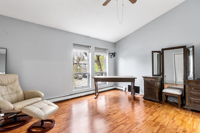 living area featuring high vaulted ceiling, ceiling fan, baseboard heating, and light wood-style flooring