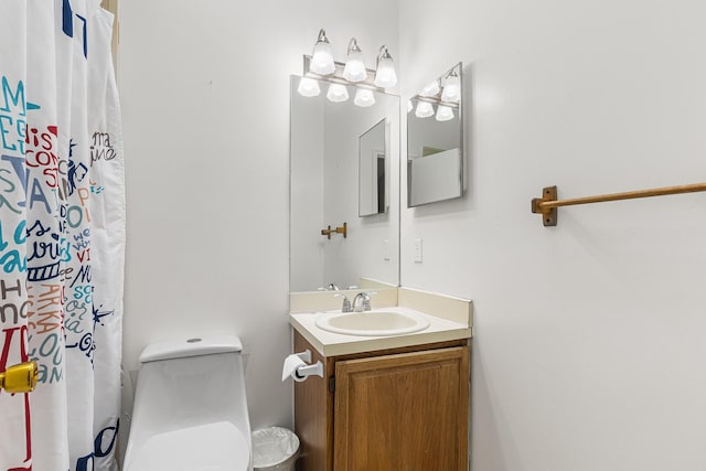 bathroom featuring vanity, toilet, and curtained shower