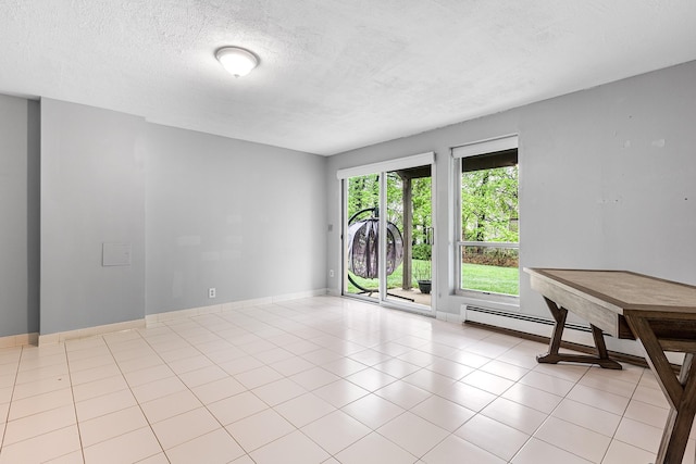 unfurnished room featuring a textured ceiling, baseboards, and tile patterned flooring