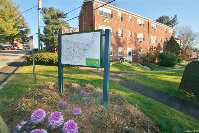 view of home's community with a yard
