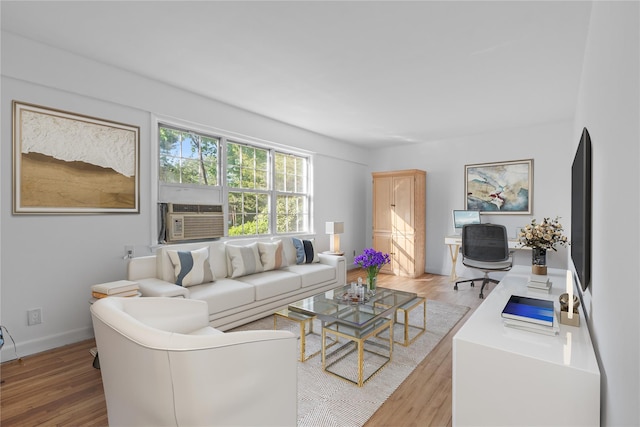 living room with light wood-type flooring, baseboards, and cooling unit