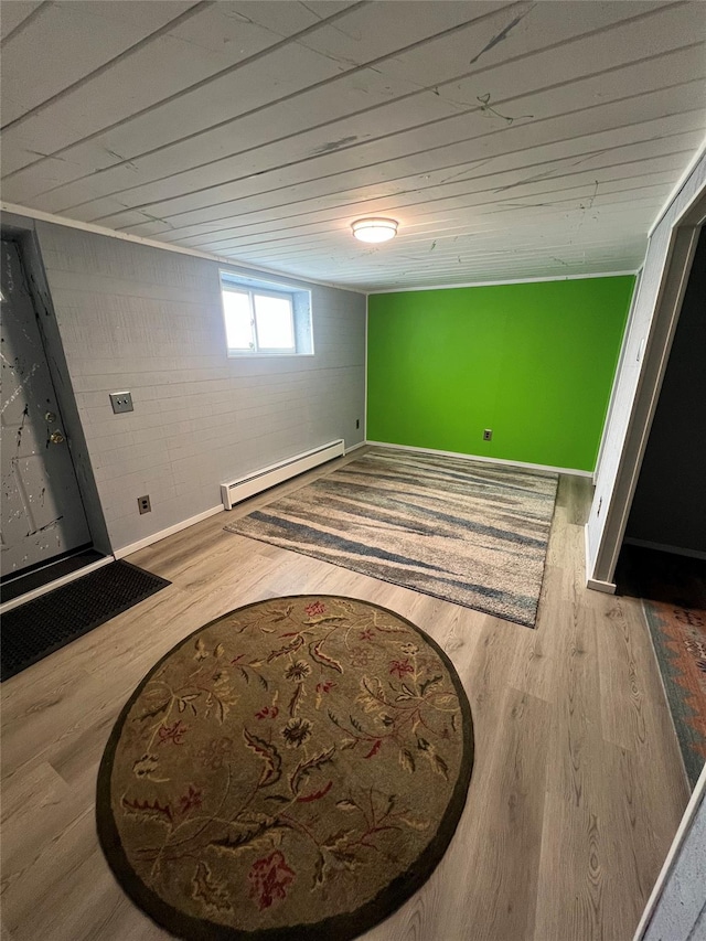 below grade area featuring baseboards, wood ceiling, wood finished floors, and baseboard heating