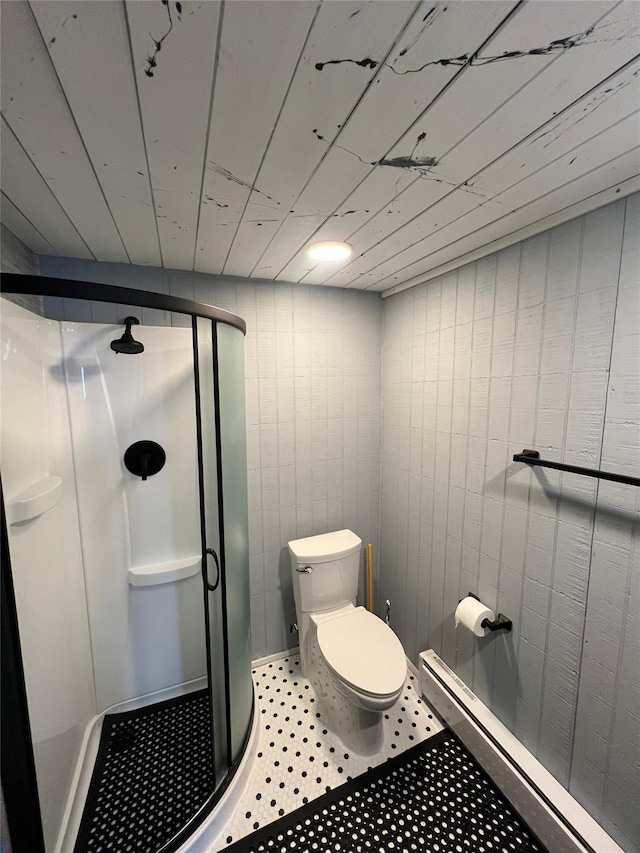 bathroom featuring a baseboard heating unit, a stall shower, and toilet