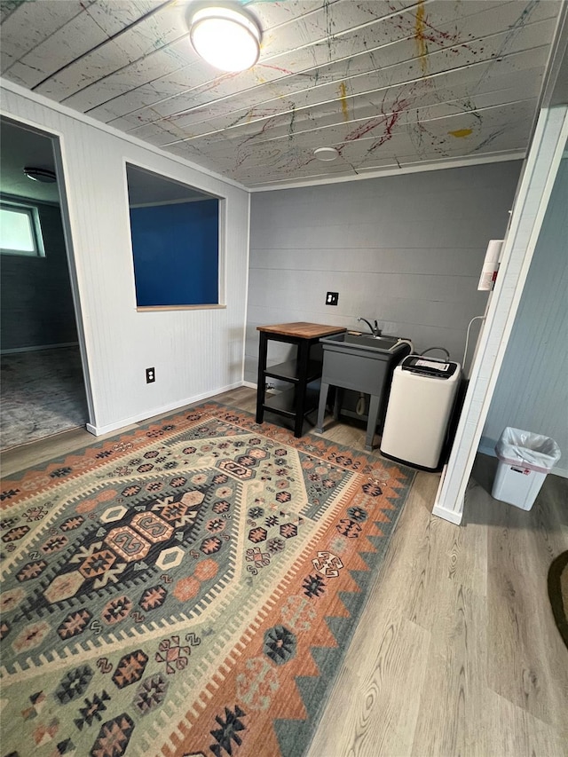 interior space featuring baseboards and wood finished floors