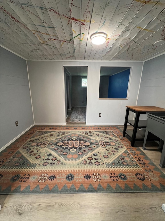 basement featuring baseboards and wooden ceiling