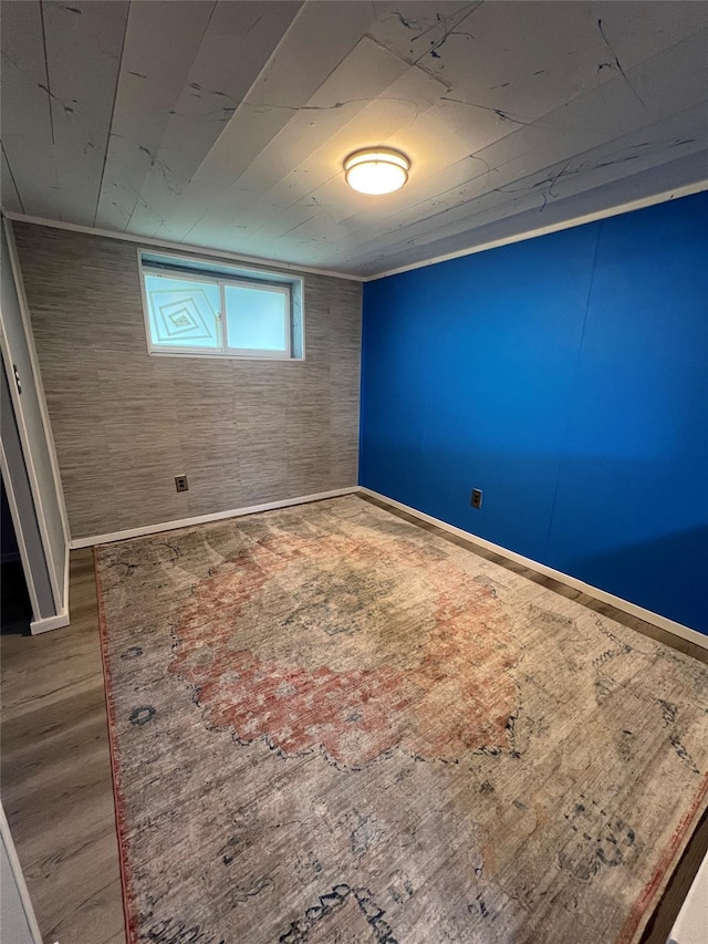 unfurnished bedroom with baseboards and wood finished floors