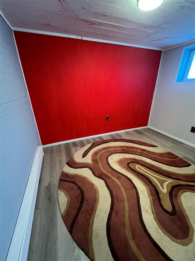 empty room with wood walls and wood finished floors